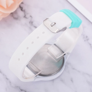 Détail du bracelet en silicone blanc avec passant vert menthe et fond en acier brossé