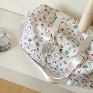 Detail of cute Hello Kitty cartoon pattern on large capacity travel bag with handles