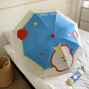 Blue and cream umbrella with stars and apple pattern including a matching storage sleeve