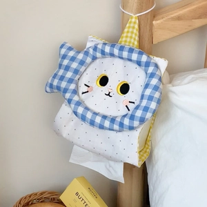 Hanging cute cat tissue holder made of cotton fabric displayed on a wooden bed frame