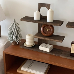 Detail view of a vintage multi-tier wooden tabletop display shelf with round cutout accents