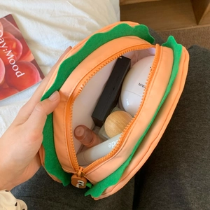 Detail view of large burger shaped makeup bag showing interior storage capacity