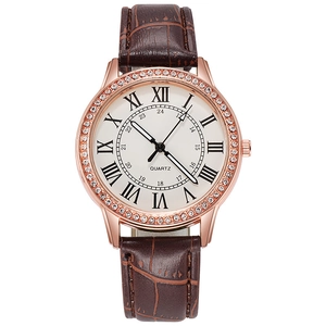 Detail of rose gold bezel with crystals and Roman numerals on women's quartz watch
