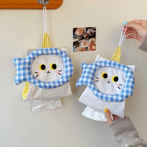 Close-up of cute cat-shaped tissue holder with detailed embroidery and blue fish border