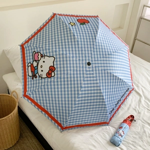 Detail of blue and white checkered folding umbrella with cute Hello Kitty pattern