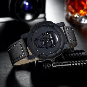 Detail of black skull embossed dial on men's sports watch with white stitched leather strap