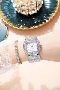 Close-up of luxury silver women's tonneau watch with rhinestones and matching bracelet