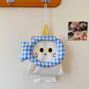 Close-up of hanging fabric tissue holder with cat design and polka dot pattern