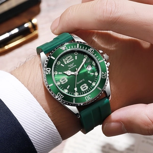 Business professional wearing a green quartz watch with silicone strap and date magnifier