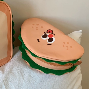 Detail showing the sandwich-shaped makeup bag with creative layers and a cute cartoon face