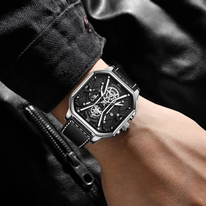 Macro view of men's square silver steel watch with black leather strap and textured dial