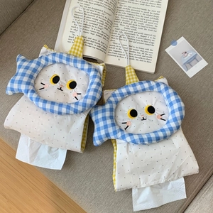Detail of cute cat-shaped fabric tissue holder with blue fish patterns and embroidery