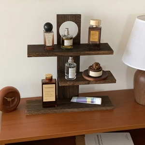 Three-tier dark solid wood tiered display rack with perfume and home decor accessories