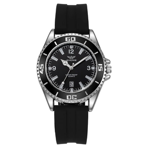 Macro detail of men's quartz sports watch with black silicone strap and calendar window