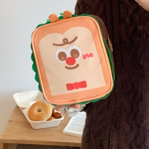 Detail of cute toast makeup bag with embroidered face and wavy green trim details