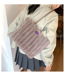 Detail of plush tote bag in mauve with vertical stripes and fashion embroidery patch