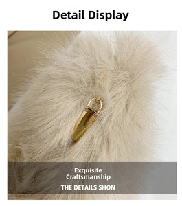 Macro view of fluffy faux fur texture and gold metal buckle on a beige dumpling bag