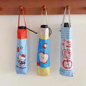 Detailed view of compact umbrella storage pouches with star and apple cartoon patterns