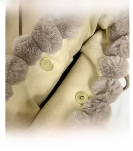 Detail of golden magnetic snap closure on a plush faux fur tote bag with fabric lining