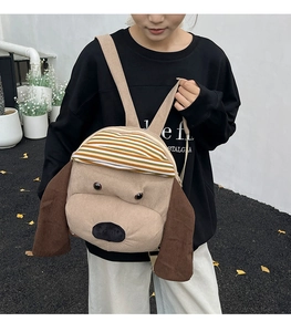 Detail of cute puppy backpack in corduroy fabric with striped cap on a female model