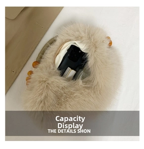 Interior view of beige plush bag showing capacity for phone and cosmetics with bead handle
