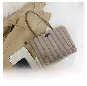 Detailed plush tote bag showing vertical quilted texture and FASHION GIRL label detail