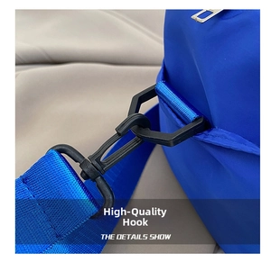 Detail of durable black swivel hook and blue nylon webbing on the women's handbag