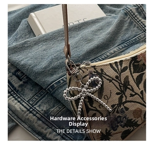 Detailed close-up of vintage floral jacquard fabric with silver metal bow charm
