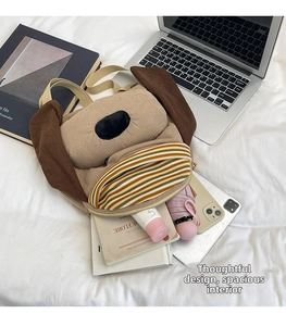 Detail of cute puppy corduroy backpack showing large capacity for books and umbrella