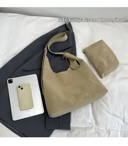 Large khaki suede hobo tote bag shown with iPad and phone for size reference