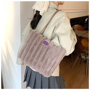 Close-up of soft plush tote bag with ribbed texture and blue fashion girl label