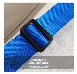 Detail of blue nylon adjustable shoulder strap with black plastic buckle and woven texture