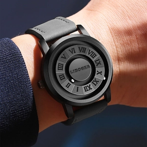 Detail view of magnetic ball watch with roman numerals and grey leather strap