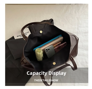 Large dark brown tote bag interior capacity showing tablet, umbrella and books