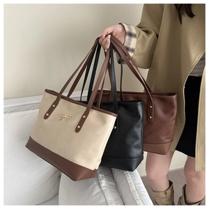 Three elegant tote bags with metallic bow detail shown in beige, black and brown colors