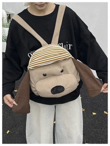 Detailed macro view of the 3D dog-shaped corduroy backpack with cute ears and striped hat