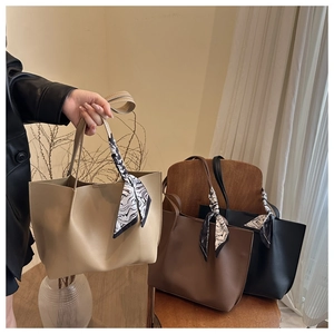Macro detail of pleated tote bags in beige black and brown with decorative silk scarves