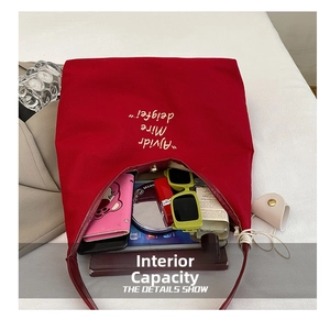 Detailed internal view of large red canvas tote bag showing spacious storage for cosmetics