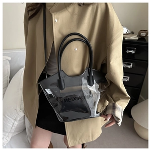 Detailed look of transparent PVC bucket bag with black trim and inner pouch for women