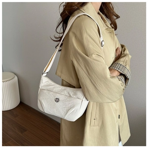 Detailed close-up of the white nylon hobo bag featuring pleated texture and metal logo