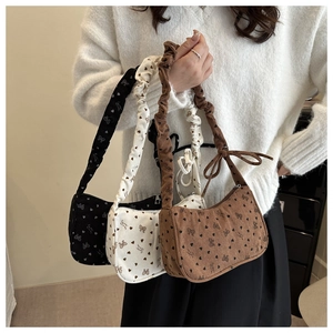 Floral dumpling bag in corduroy with heart bow prints and ruched handle detail