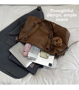 Brown leather satchel showing large capacity for laptop, tablet, and daily essentials