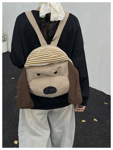 Detail of cute puppy corduroy backpack with striped hat worn by a model