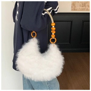 Close-up of white faux fur hobo bag with vibrant orange wooden bead handle detail