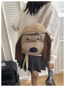 Detail of light brown corduroy dog-shaped backpack with adjustable strap on model