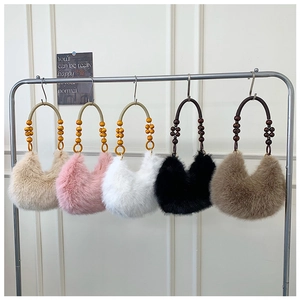 Detailed row of plush dumpling bags in five colors with unique wooden bead handles