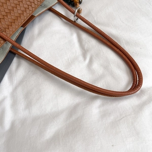 Sac fourre-tout tressé marron avec texture cuir fine et anneaux métalliques aux bretelles