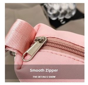 Detailed macro view showing the smooth metal zipper on a pink waterproof fitness yoga bag