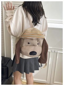Detail of cute puppy corduroy backpack showing adjustable strap and soft plush texture