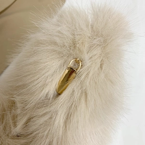 Plush beige faux fur handbag featuring a premium polished gold rectangular metal zipper